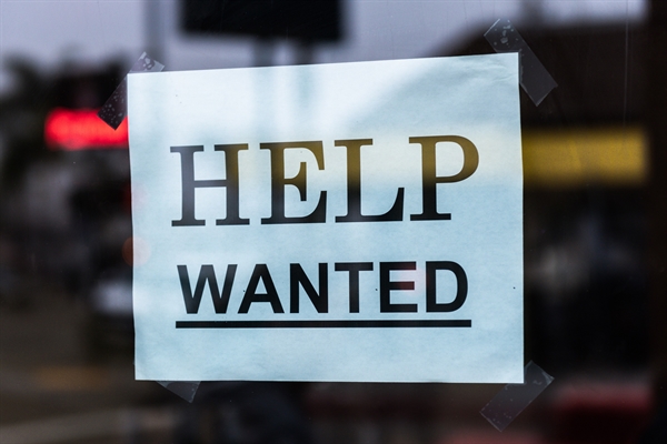 Image of Help Wanted sign in shop window