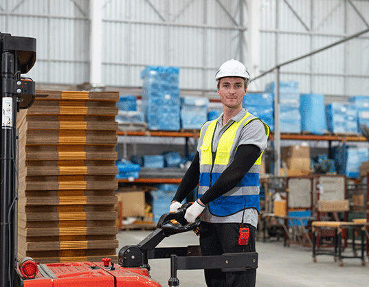 Temporary worker operating a fork lift truck in a warehouse